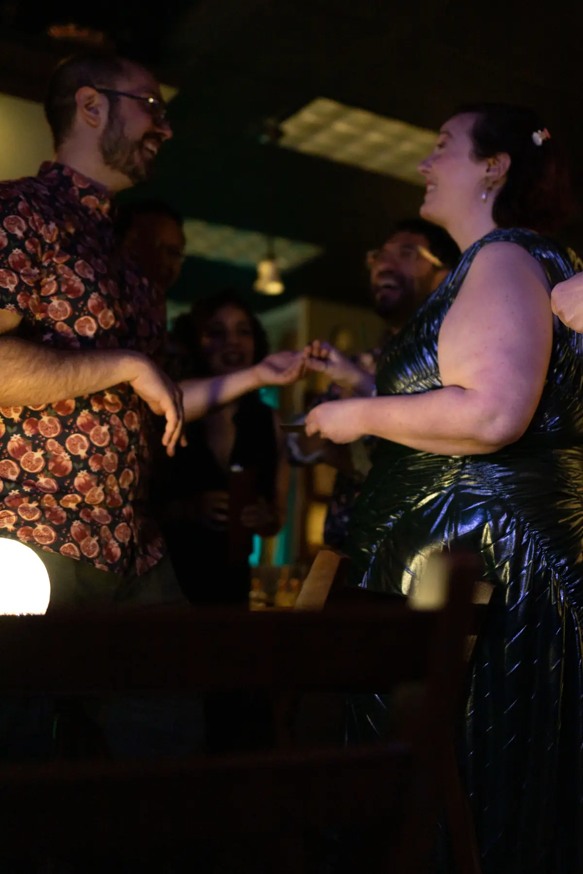 Guests joining hands in warm low light