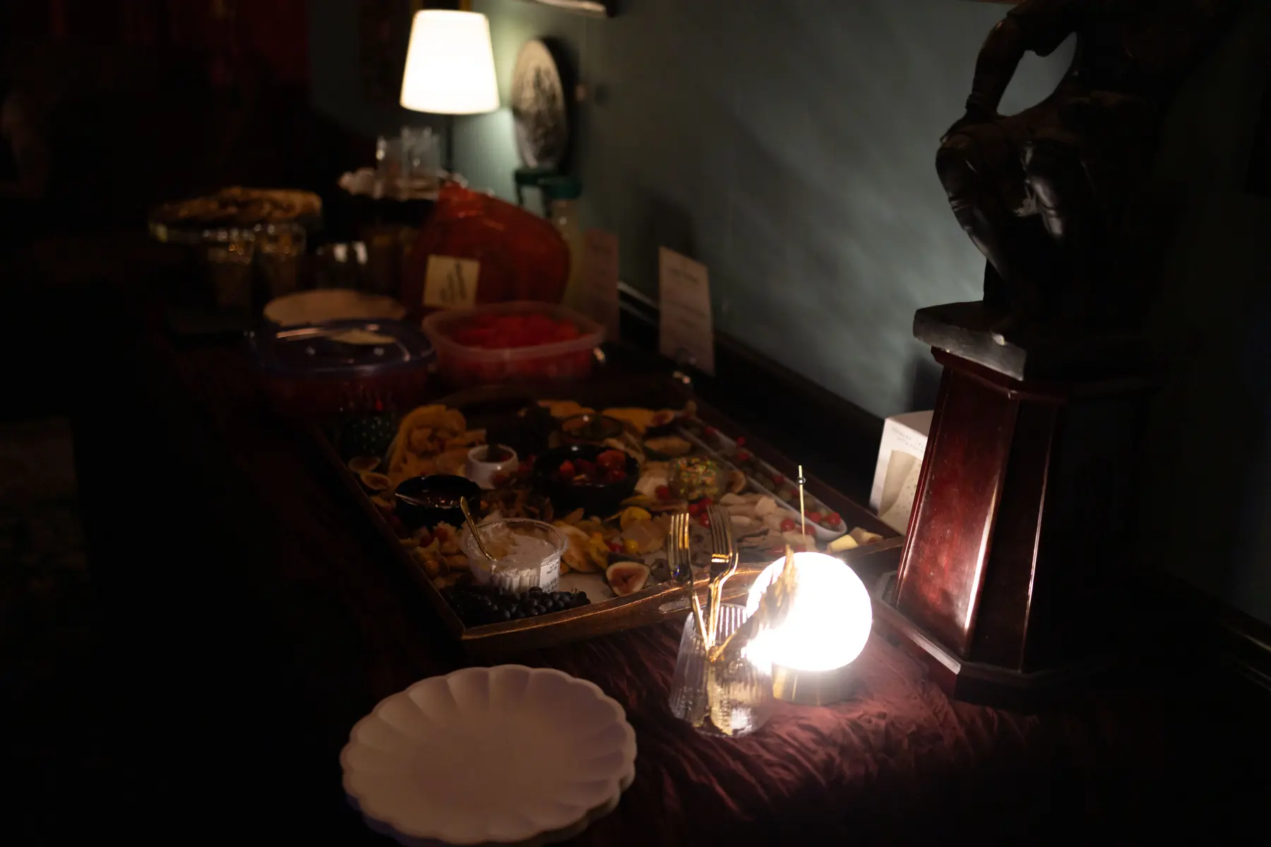 Guests gathering around a low-lit feast table