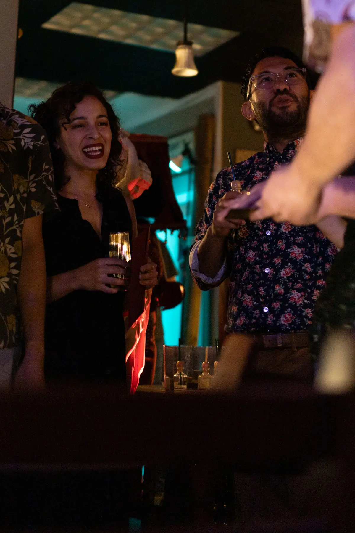 Guests laughing together in warm low light