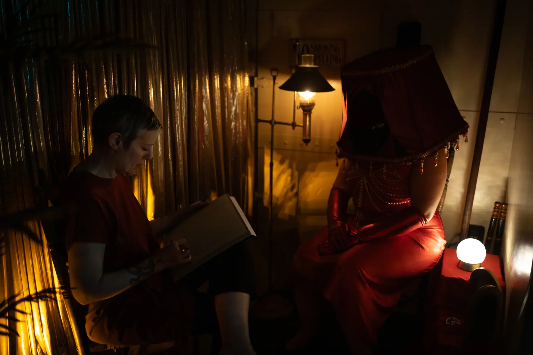 A seated guest sharing a quiet reading beneath warm light