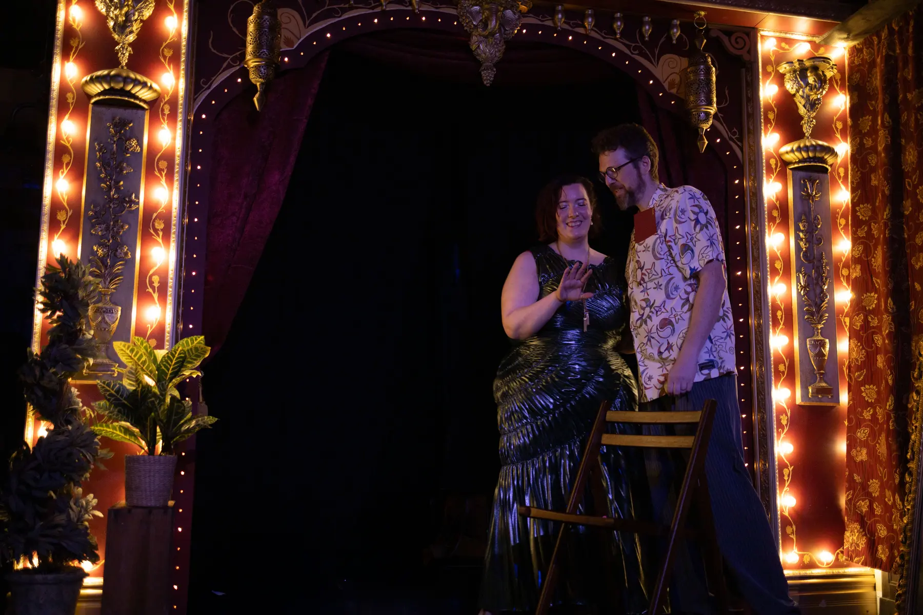 The birthday ritual taking place on a small illuminated stage