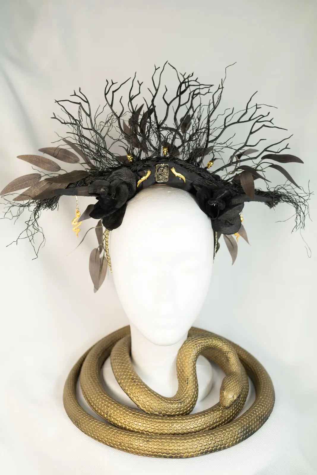 Gold and black headpiece with tarot and serpent details