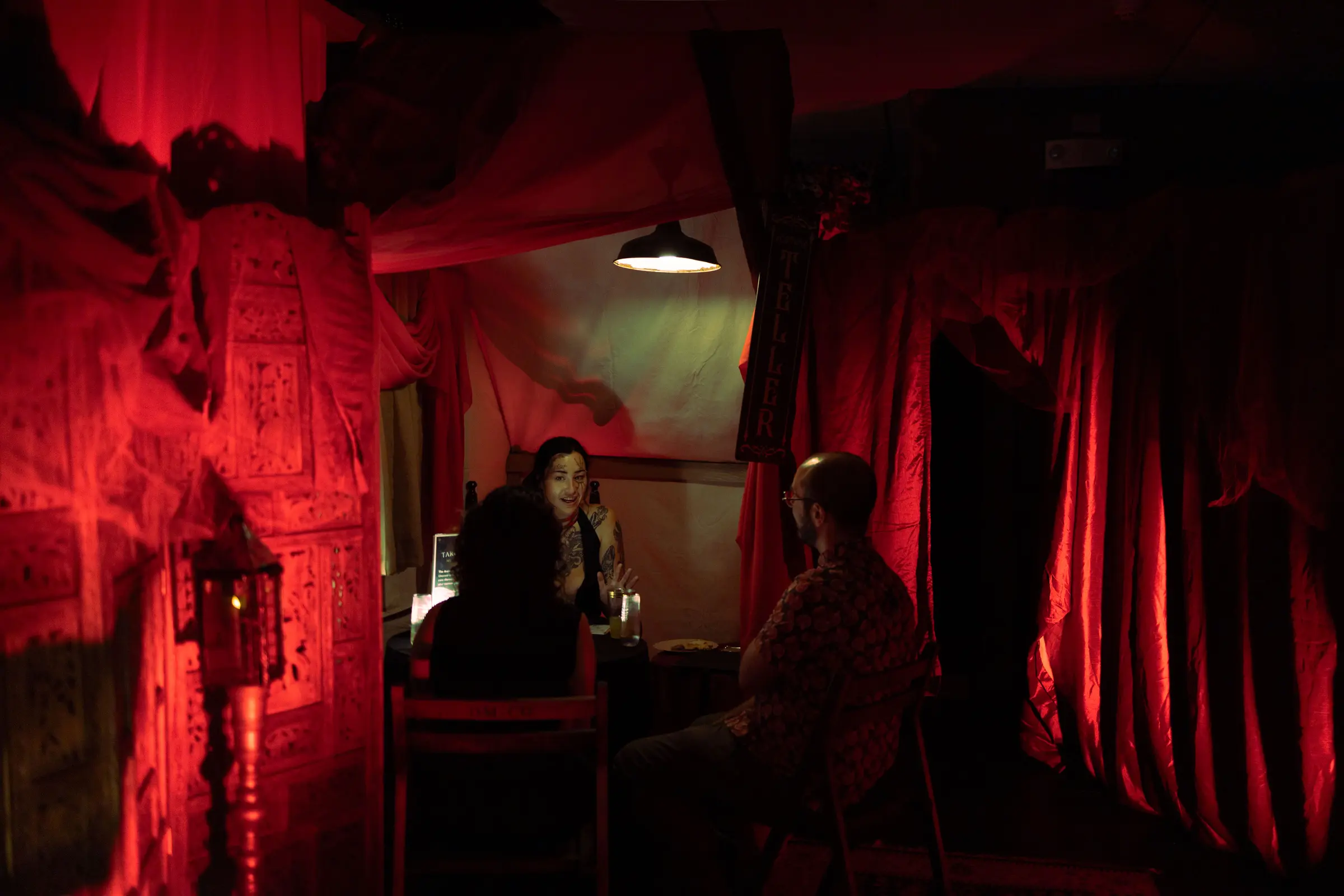 A candlelit red room prepared for The Fool’s Journey